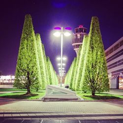 Illuminated street light against sky at night