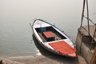 High angle view of sailboat moored on sea against sky