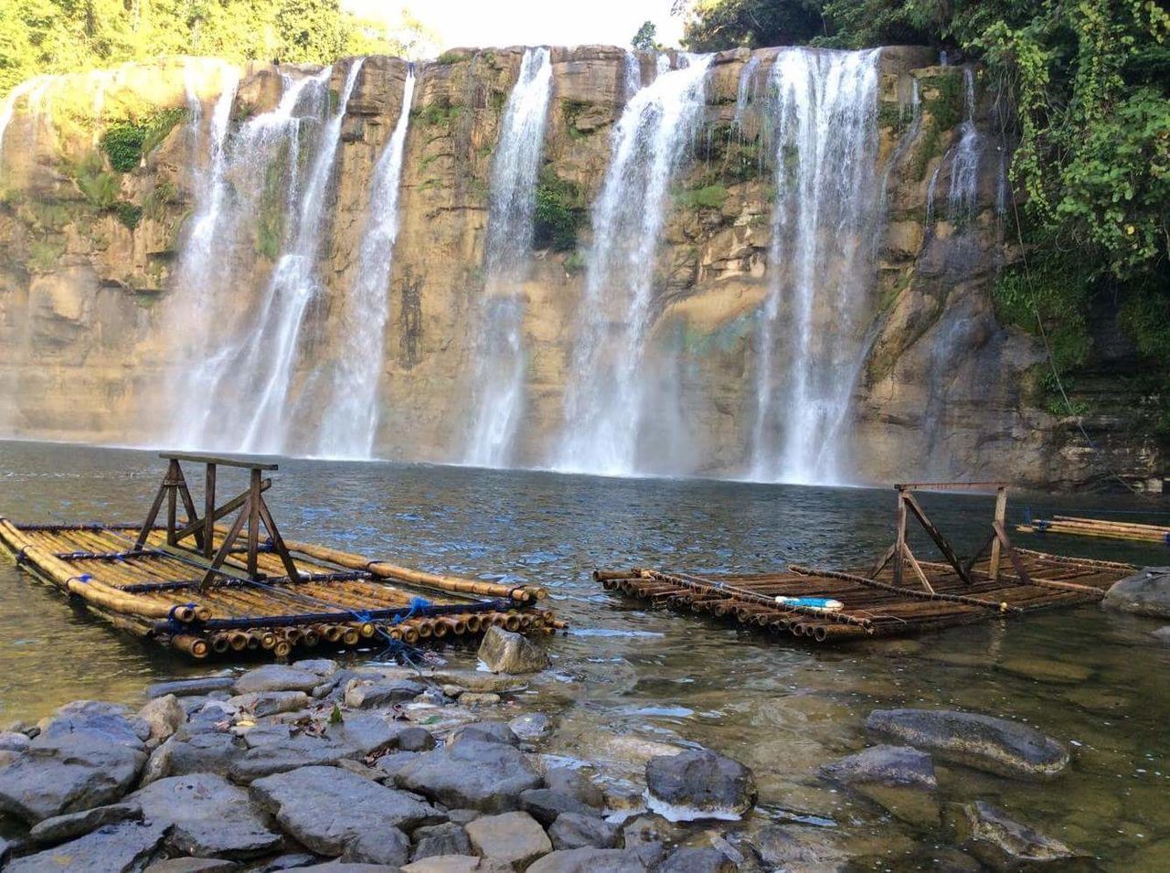 SCENIC VIEW OF WATERFALL AGAINST ROCKS