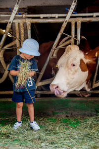 Full length of man standing by barn