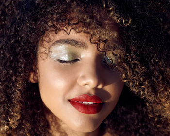 Close-up of young woman with curly hair