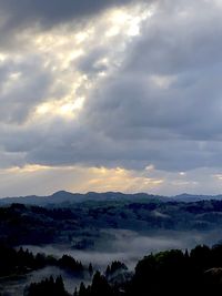 Scenic view of silhouette mountains against sky at sunset