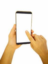 Low angle view of hand holding smart phone against white background