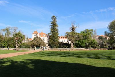 Lawn in front of palacio do marques de pombal against sky