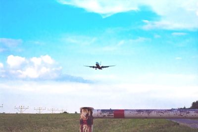 Low angle view of airplane flying against sky