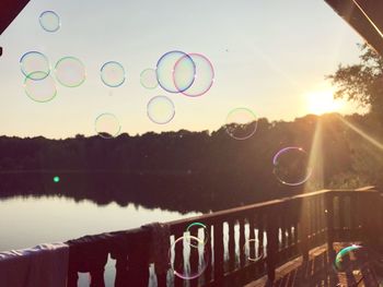 Close-up of bubbles against rainbow in sky