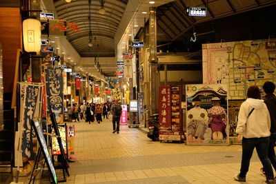 People walking in illuminated market