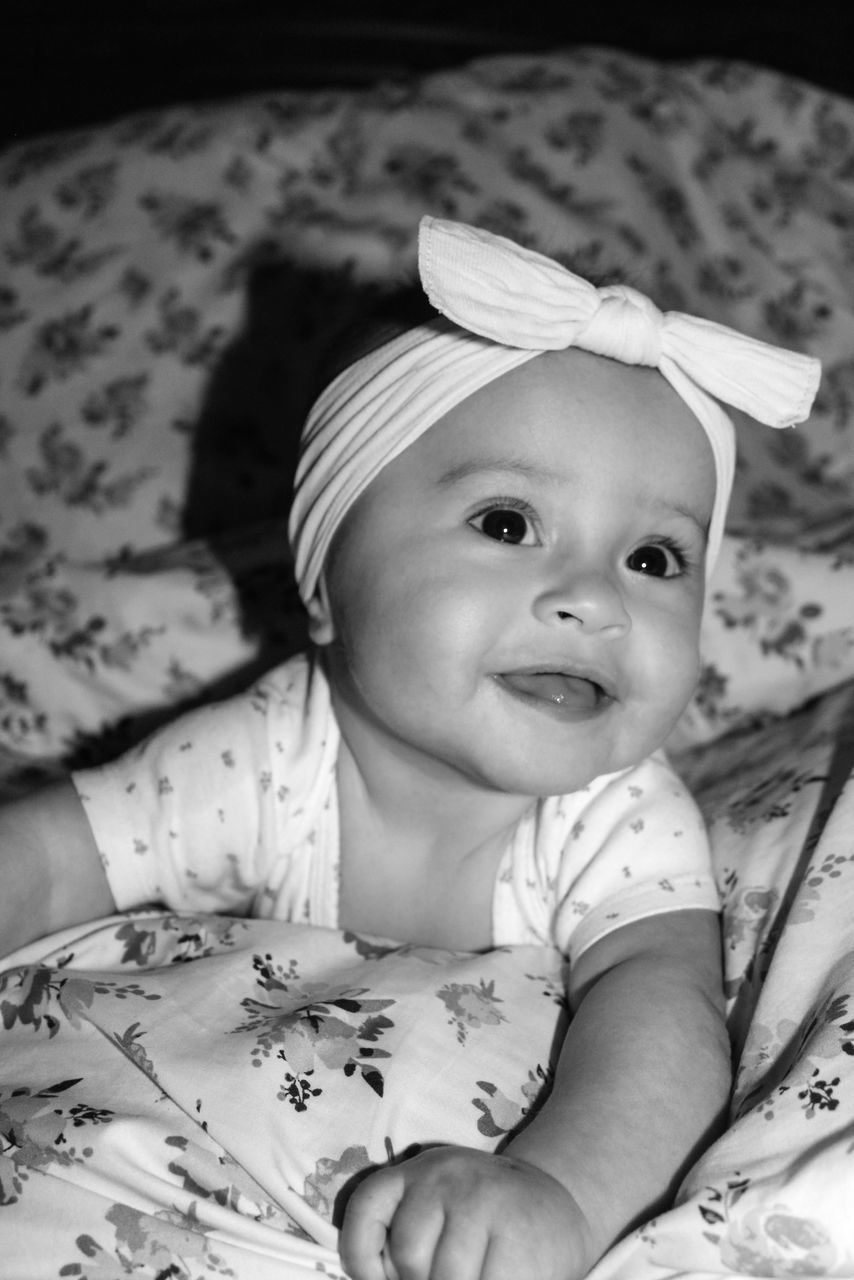 child, childhood, baby, cute, black and white, portrait, white, one person, innocence, monochrome photography, person, indoors, monochrome, clothing, portrait photography, babyhood, bed, baby clothing, emotion, toddler, looking at camera, lying down, skin, happiness, smiling, furniture, hat, female, lifestyles, front view, looking, headshot, women, high angle view, home interior