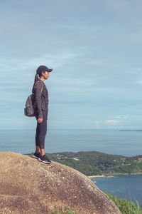 Full length of woman standing on sea against sky