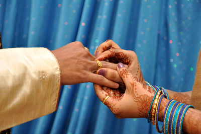 Midsection of couple holding hands