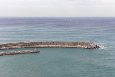 Scenic view of sea with lighthouse. aerial view of seascape with pier.