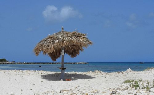 Umbrella on beach against sky