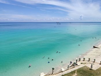 People on beach against sky