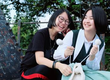 Portrait of a smiling girl sitting outdoors