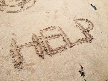 Help wrote on the beach