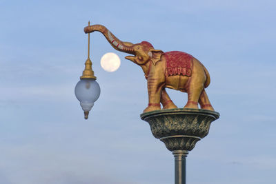 Low angle view of statue of street light