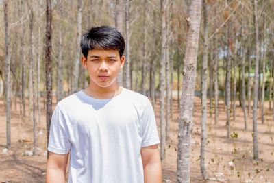 Portrait of young man standing on land