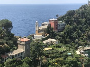 High angle view of buildings by sea against sky