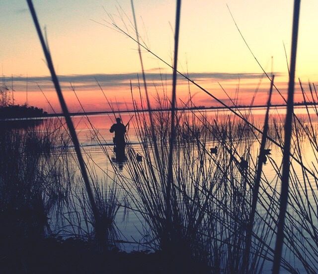 sunset, water, silhouette, scenics, tranquil scene, tranquility, orange color, beauty in nature, sea, sky, nature, horizon over water, sun, idyllic, reflection, lake, rippled, leisure activity