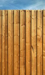 Close-up of wooden fence against sky