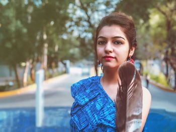 Portrait of young woman in public park