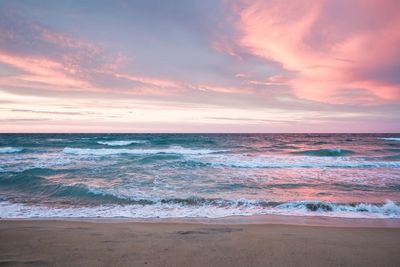 Scenic view of beach against sky during sunset