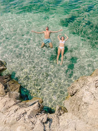 High angle view of couple enjoying at sea shore