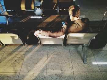 Rear view of man on seat at airport