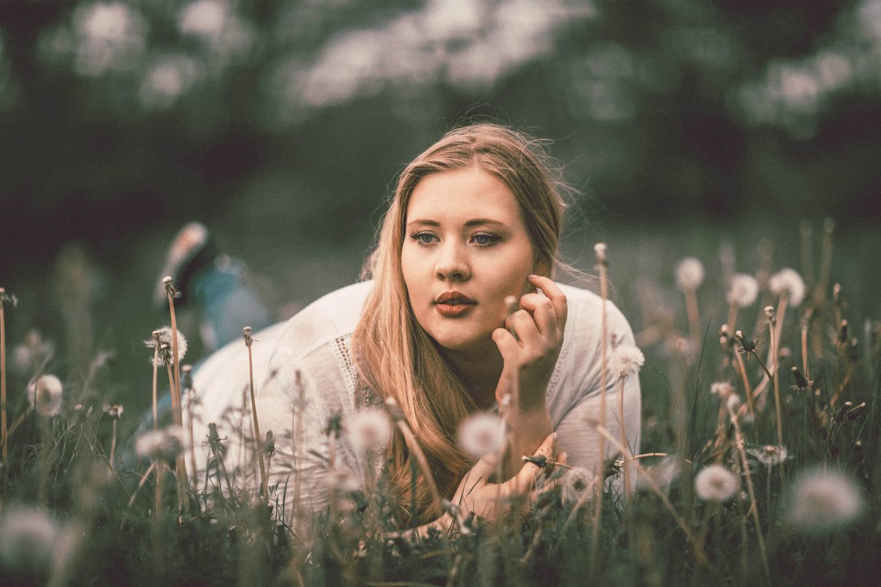 young adult, young women, nature, one person, leisure activity, outdoors, real people, field, beautiful woman, beauty, lifestyles, blond hair, flower, summer, portrait, women, sitting, day, grass, beauty in nature, adult, people