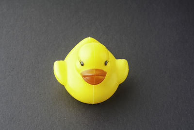 Close-up of yellow toy over black background