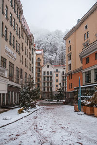 Snow covered buildings against sky