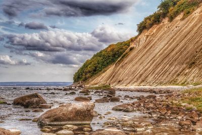 Rocks on beach against sky