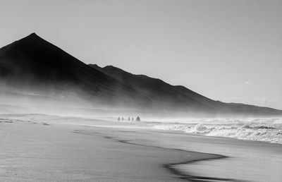 Scenic view of beach against clear sky