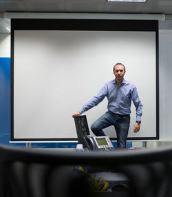 Full length of man standing in office