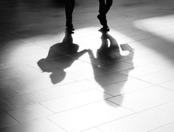 Low section of man on tiled floor