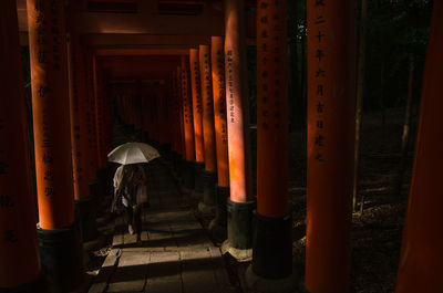 Man walking in corridor of temple