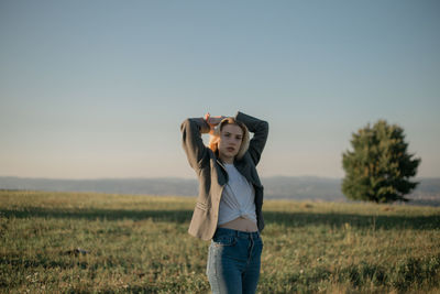 Full length of woman standing on field