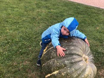 High angle view of boy on grassy field