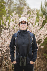 Portrait of confident female hiker with hands in pockets standing at redwood national and state parks