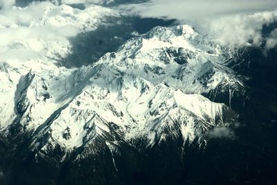 Low angle view of snow covered mountain against sky