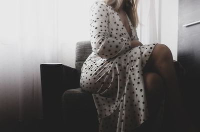 Woman sitting on chair at home