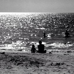 Scenic view of people relaxing on beach