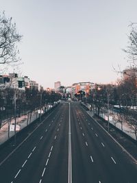 Road by city against clear sky