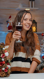 Portrait of smiling woman holding wineglass