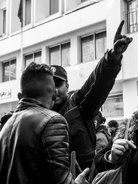 Men standing on street in city