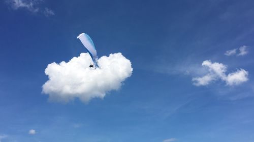 Low angle view of vapor trail against blue sky