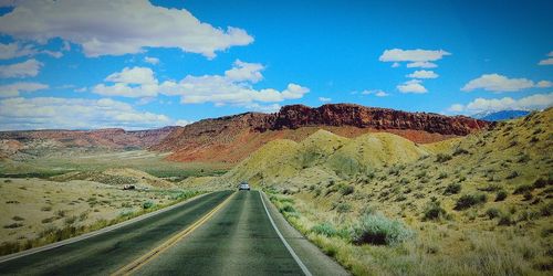 Road amidst landscape against sky