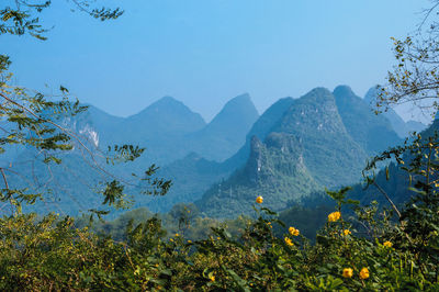 Scenic view of mountains against clear blue sky