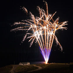 Low angle view of firework display at night