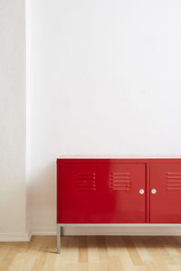 Red wooden floor against wall at home